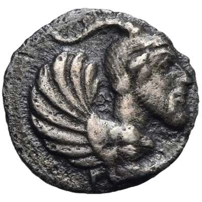Forepart of a human-headed monster right, bearded, with goat's horns, curled wings and a lion's paw; border of dots.