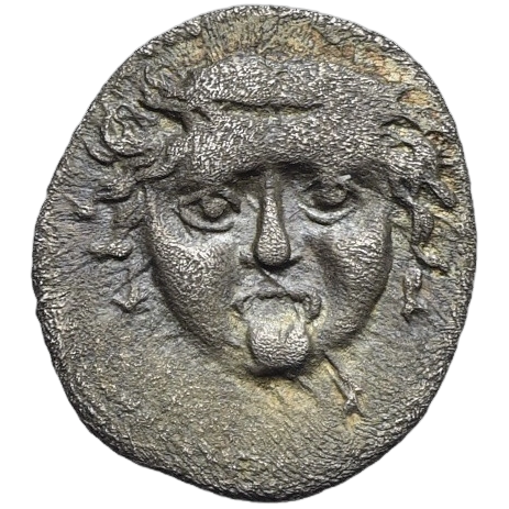 Gorgoneion head facing with protruding tongue; border of dots.