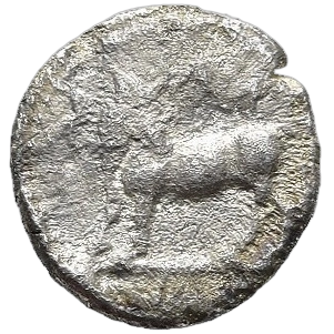 Man-headed bull standing left, head reverted.